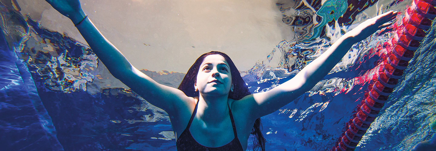 a woman swimming under water