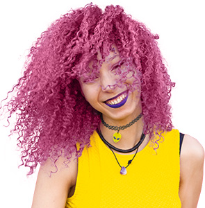 Image of a person smiling with curly pink hair