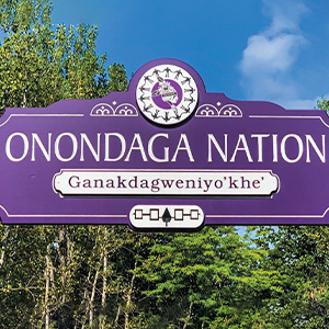 A purple sign welcoming people to the Onondaga nation