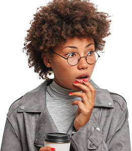 Image of a shocked person holding a cup of coffee