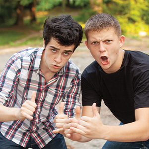 Image of two teens giving two thumbs up